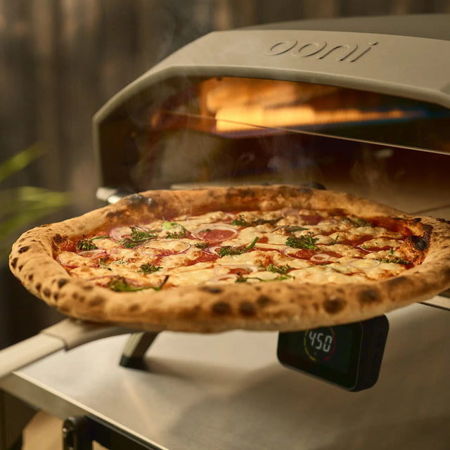 wide turning peel retrieving pizza from oven 