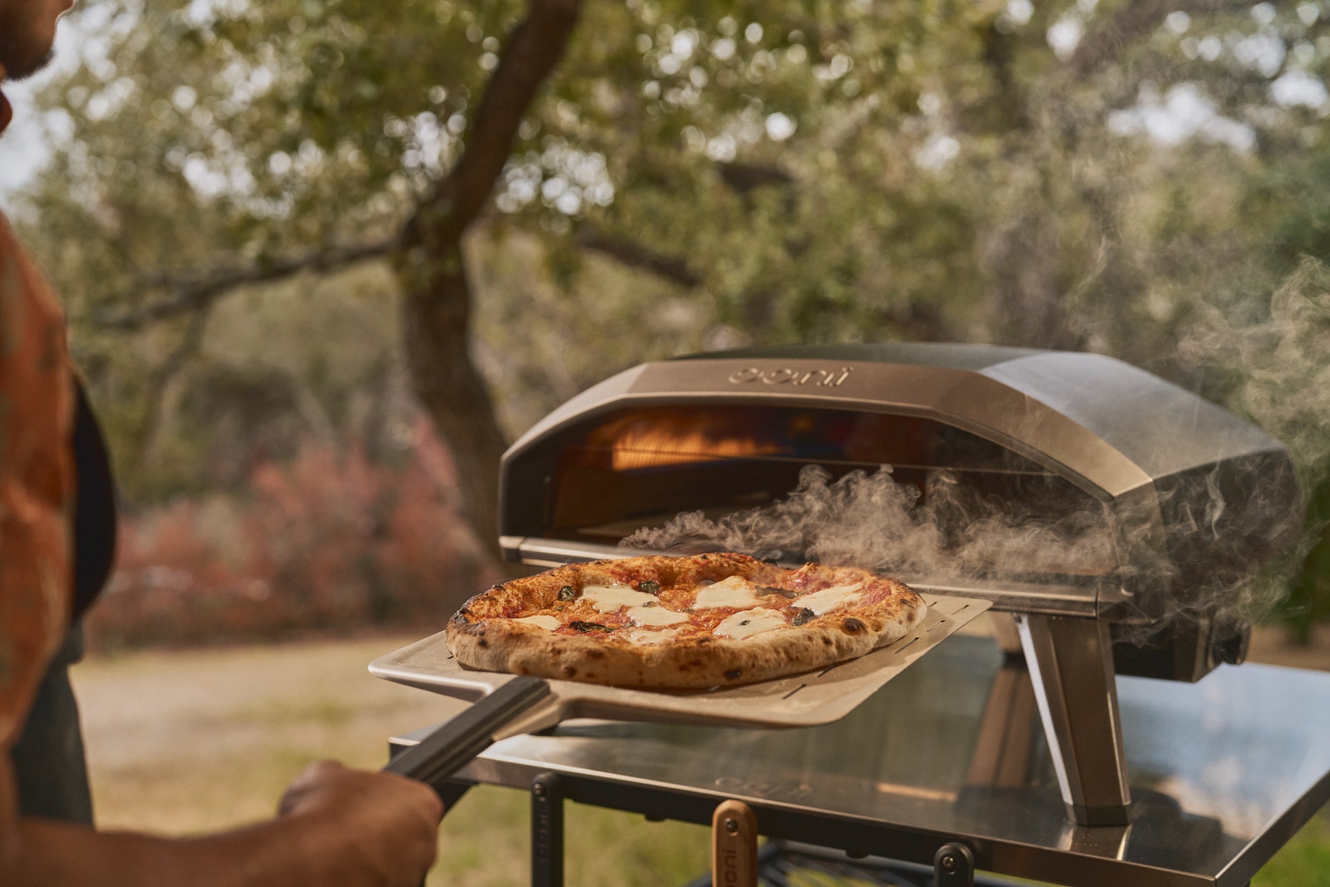 Koda 2 Pro gas Powered pizza oven. Pizza being retrieved from oven 