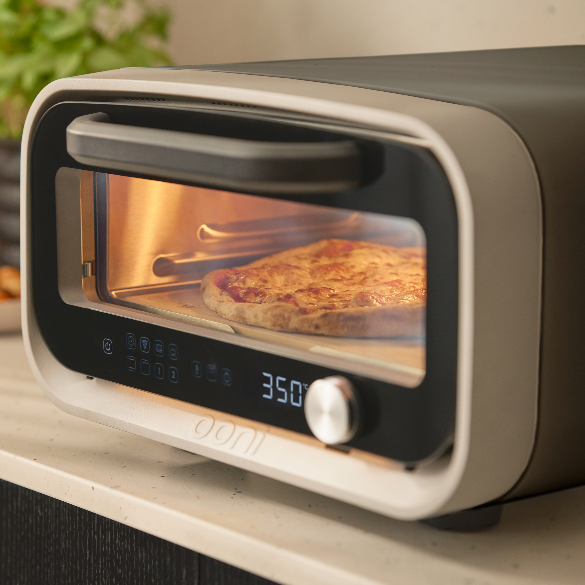 volt 2 electric pizza oven with pizza cooking inside